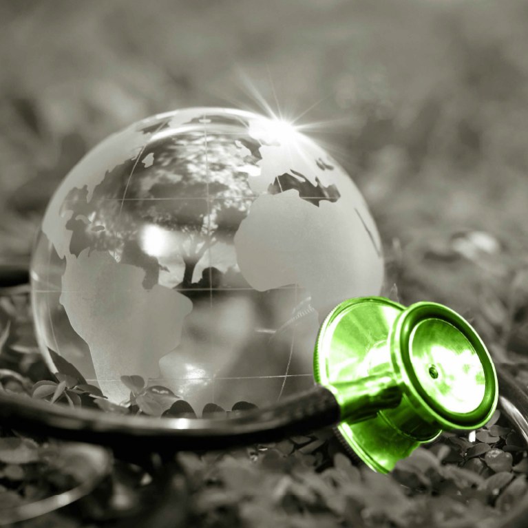 green glass globe with stethoscope around it