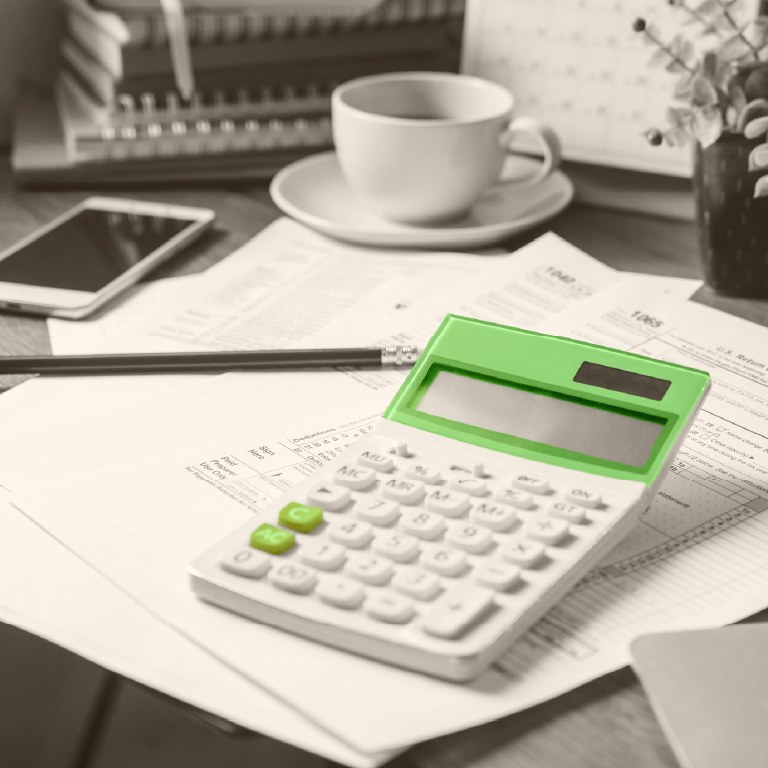 green calculator among lots of paperwork