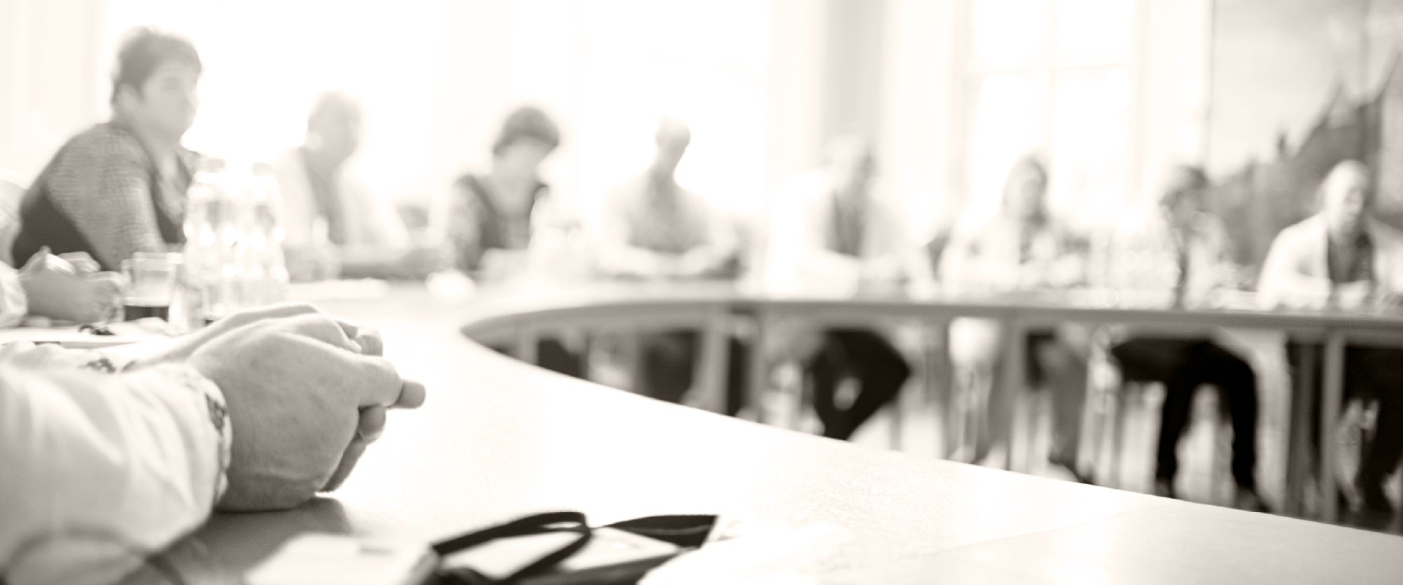 chairs and boad members around a conference table