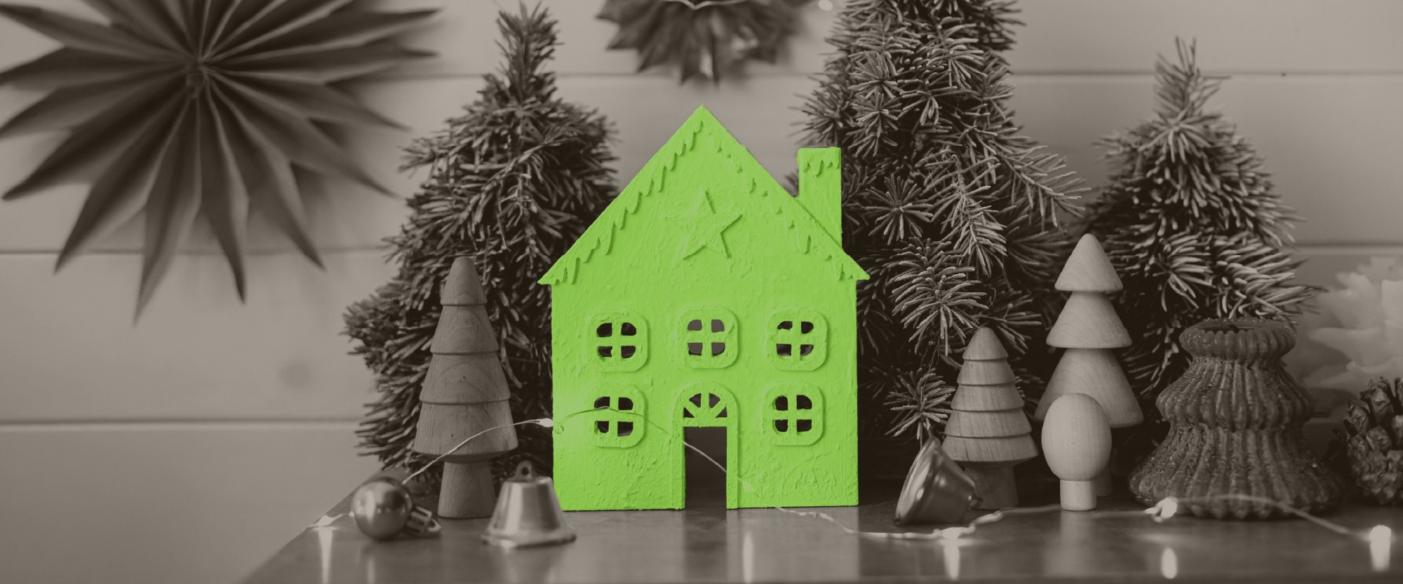 green house with pine trees and silver bells around it