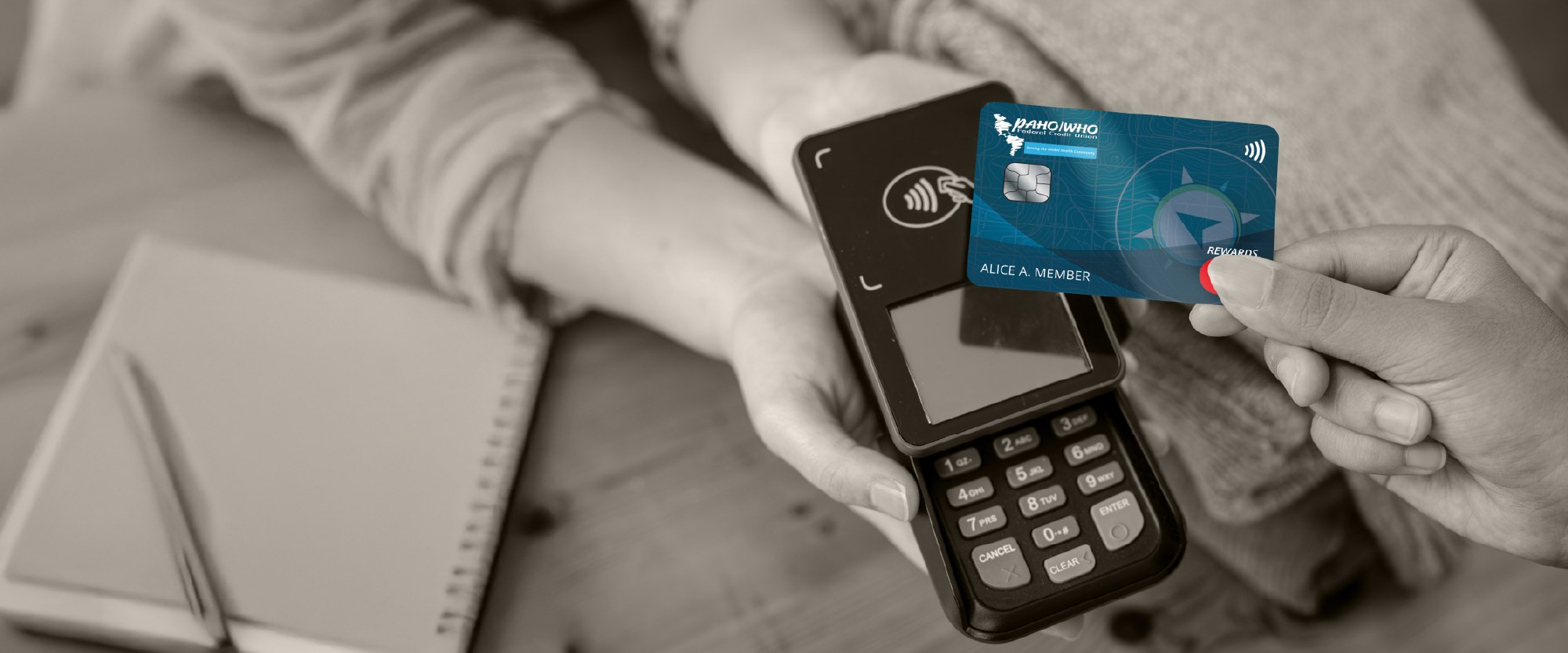 paying with a World rewards card on a desk